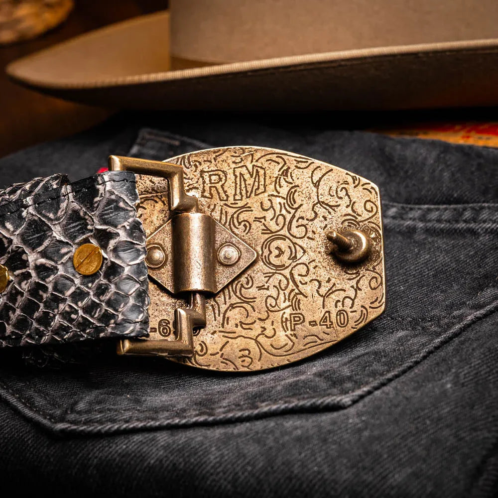 Lifestyle image of ARKANSAS python skin belt worn with jeans and a tucked shirt outside.