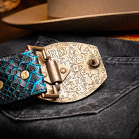 Close-up lifestyle photo showing Arkansas belt on person with hand near buckle