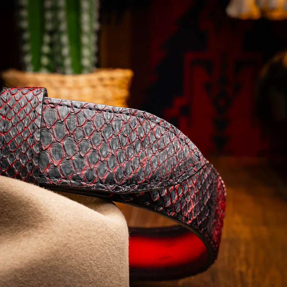 Lifestyle shot of Belgian wearing Arkansas python skin belt with Western attire outdoors.
