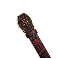 Arkansas python skin belt laid flat displaying its polished antique brass Western style buckle.