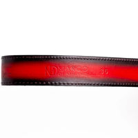 Detailed view of the Arkansas Belt's python skin scale pattern and leather lining in Black Cherry.