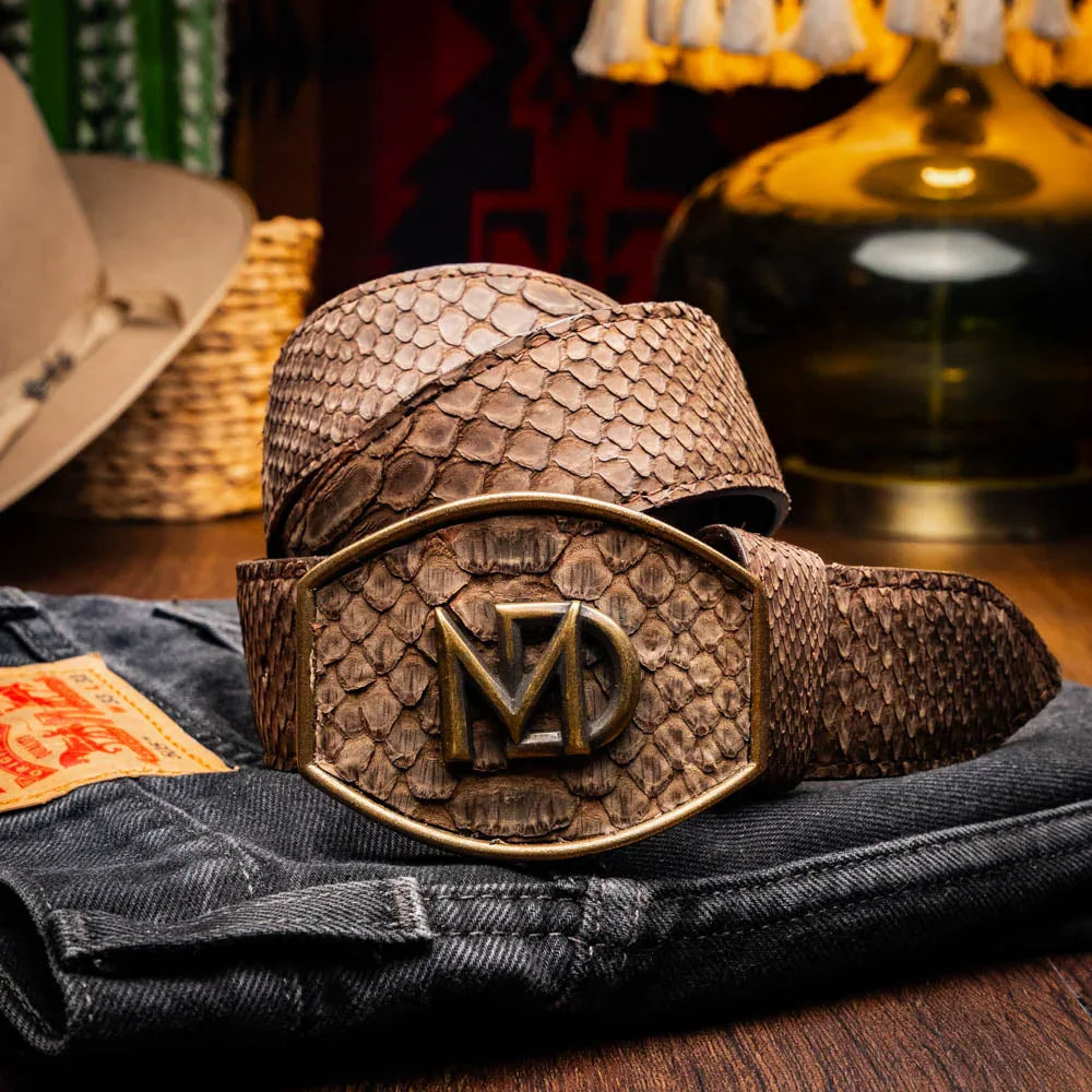 Model wearing brown python skin belt with Western style buckle and blue jeans