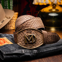 Model wearing brown python skin belt with Western style buckle and blue jeans