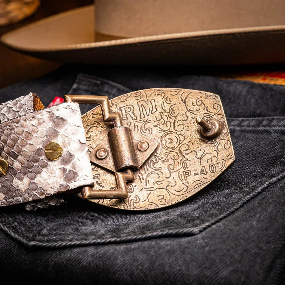 Close-up of the belt buckle and python skin texture worn with casual western outfit.