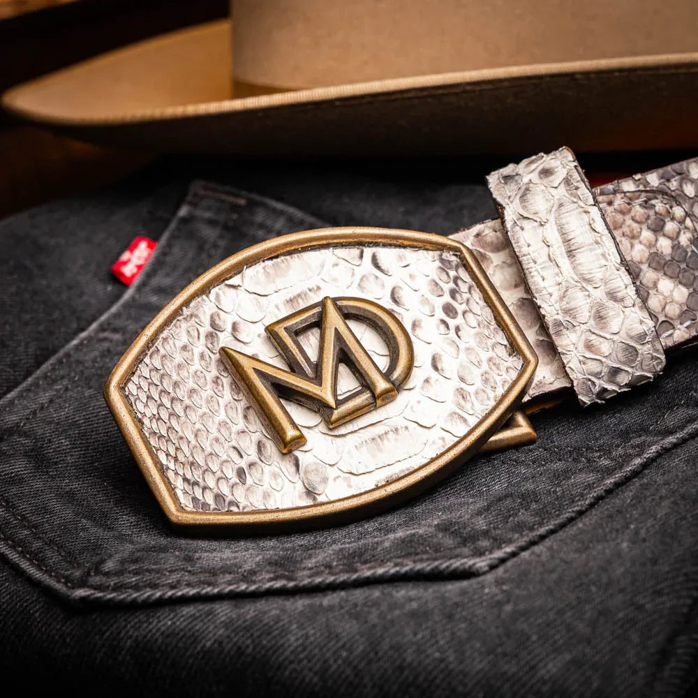 Lifestyle shot showing natural python belt paired with jeans in sunny outdoor environment.