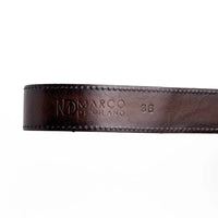 Detailed view of antique brass western buckle attached to natural python skin belt.