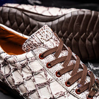 Person walking in Batistini sneakers with focus on shoe details and comfort.