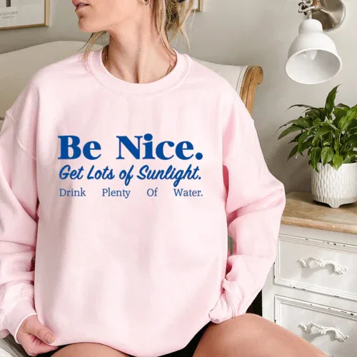 Light pink sweatshirt featuring vibrant, positive phrase about kindness and health