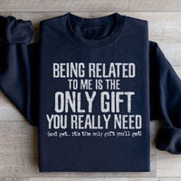 Black sweatshirt displaying the phrase 'Being Related To Me Is The Only Gift You Really Need' in white text.