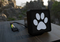 Paw Print LED Hitch Cover displayed against a black background showing LED detailing