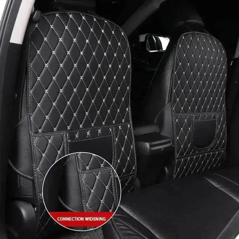 Black car seat protector pad crumpled showing flexibility and protective qualities with red thread accents.