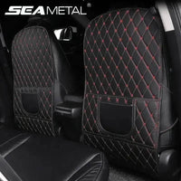 Black car seat protector pad with red stitching laid flat showing textured surface and water resistance.