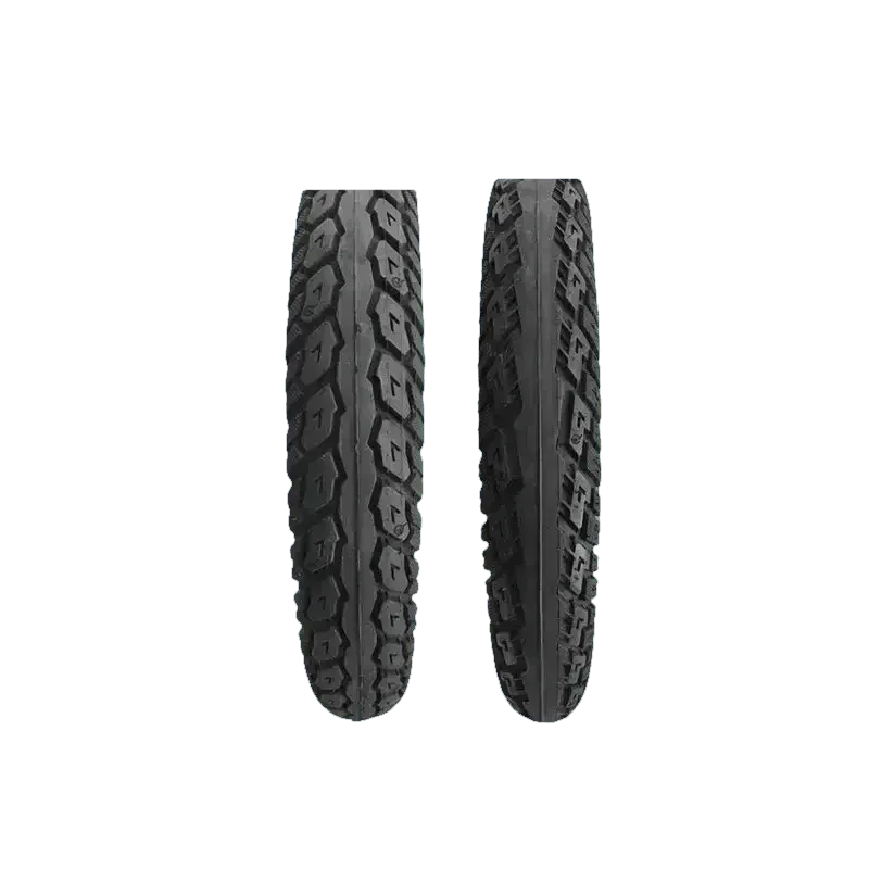 Two black CST electric bike fat tires leaning against a motorcycle wheel.