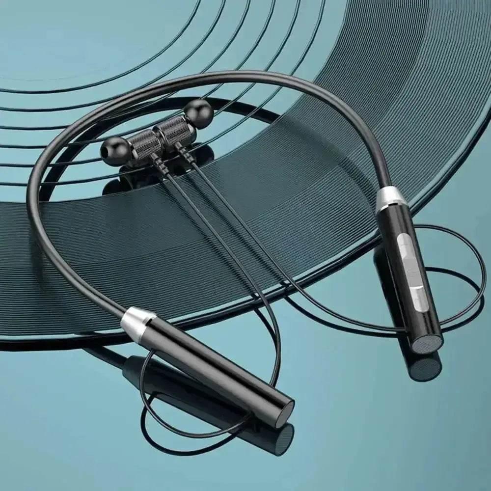 Black magnetic wireless earphones with neckband laid out on a white surface.