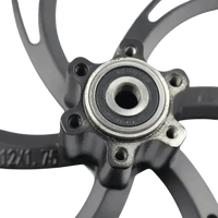 Front view of a black 12 inch motorcycle wheel hub for electric scooters, highlighting the center bearing.