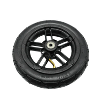 Black rubber folding electric scooter tire resting on white background with clear tread lines.
