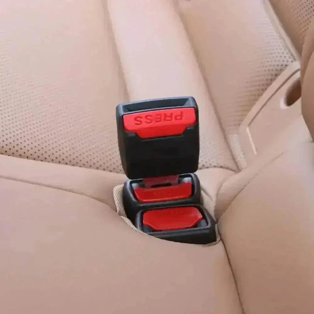 Black seat belt extender laid flat, showing its length and red connector.