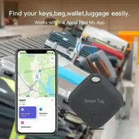 Black square Bluetooth tracker held in a hand showing its compact size.