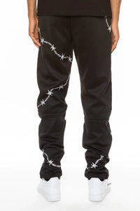 Close-up of black track pants fabric and zipper pocket on men's athletic pants