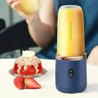 Blue portable juicer cup with a clear blending container showing fresh fruit inside.