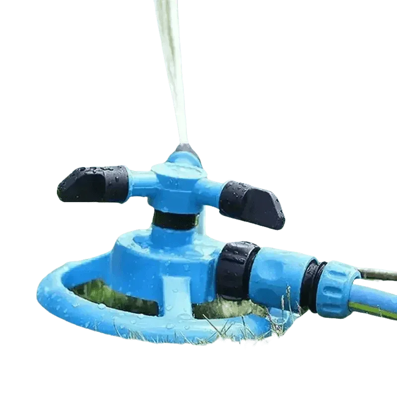 Blue automatic sprinkler evenly watering vibrant green grass in backyard.