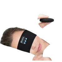 Model sleeping on side wearing gray Bluetooth sleeping headphone headband.