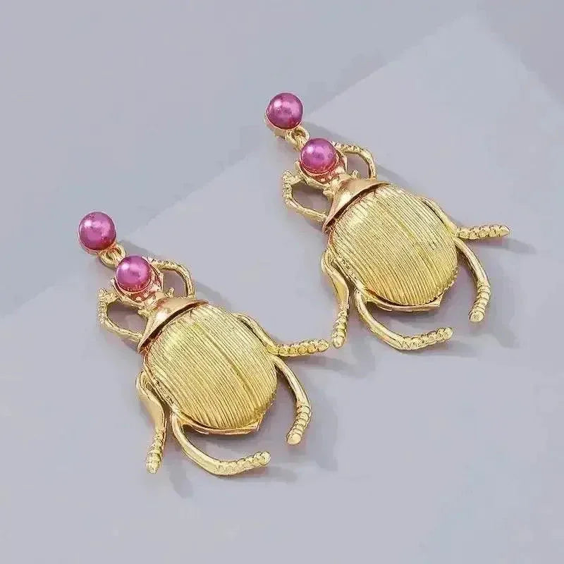Pair of metal gold-plated Bohemia earrings styled as cute vintage beetles with diamond details.
