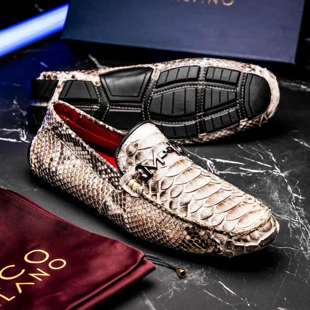 Lifestyle image of person wearing natural python driving shoes with rolled-up jeans outdoors.