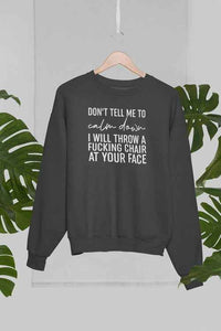 Front view of grey crewneck sweatshirt displayed against palm trees