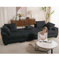 Black U-shaped sleeper sofa with corduroy upholstery and plush cushions in modern living room setting.