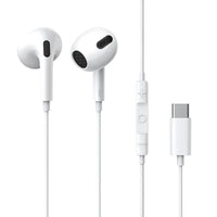 Close-up of white Type-C wired headset earplugs with cable on a light surface.
