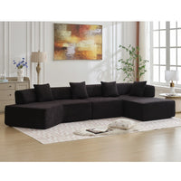 Side profile of spacious modern black L-shape sectional couch with plush seats.
