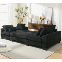 Large black U-shaped sleeper sofa with plush corduroy cushions and square arms, shown fully extended as a bed.