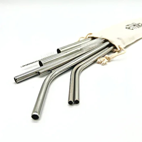 Set of reusable stainless steel straws with cleaning brush and mini cotton carrying pouch on white background.