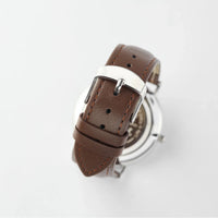 Personalized men's watch worn on wrist showing elegant copper dial and classic design.