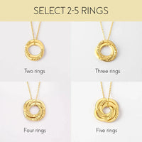 Detailed view of interlocking silver rings necklace showing smooth surfaces and engraved family names.
