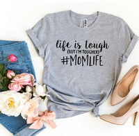 Close-up of white #Momlife T-shirt fabric with printed black and pink text design