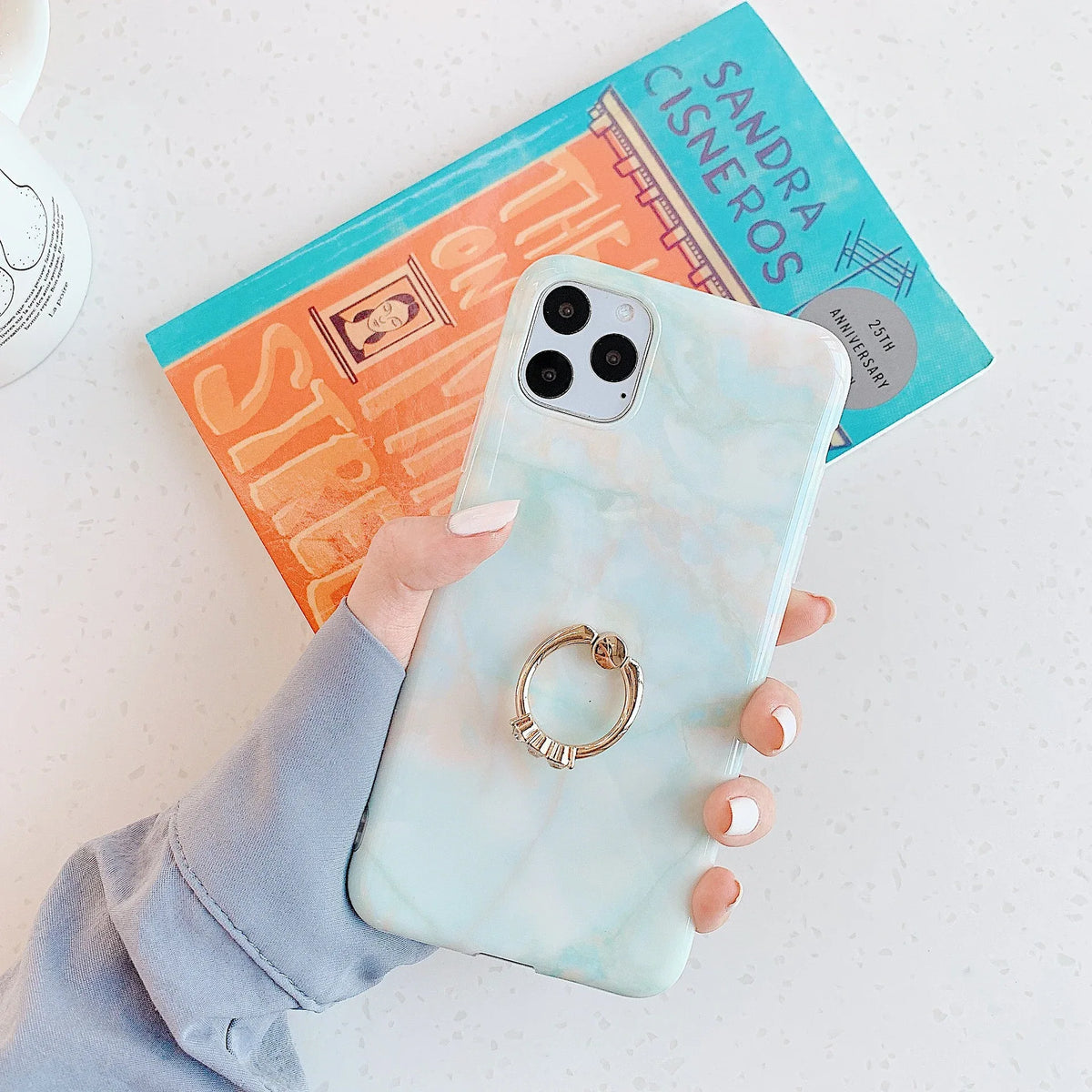 Marble pattern on iPhone case wrapping fully around edges for 360-degree protection.