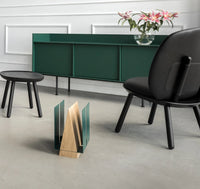 WINGS magazine rack on hardwood floor holding various magazines, illustrating its compact size.
