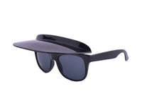 Close-up of Flipside Sunglasses showing black frame and clear vertical visor in upright position.