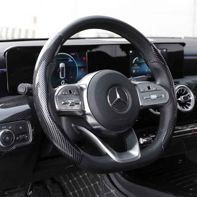 Black carbon fiber-pattern steering wheel covers fitted on a car wheel, highlighting their slim, textured design.