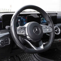 Black carbon fiber-pattern steering wheel covers fitted on a car wheel, highlighting their slim, textured design.