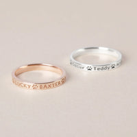 Close-up shot of a person wearing the custom pet names ring on their finger.