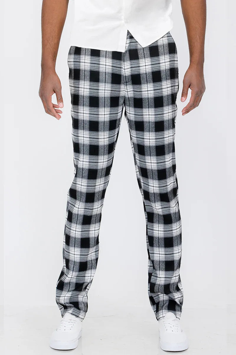 Close-up of plaid slim fit trousers showing button fly closure and fabric pattern.