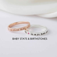 Close-up of a personalized silver ring engraved with baby names, designed for new moms.