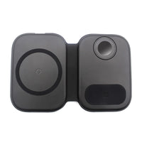 Magnetic folding 3-in-1 wireless charging station with smartphone on charging pad, placed on wooden surface.