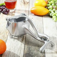 JuicyStar manual juicer with pressed orange half, demonstrating juice extraction process.