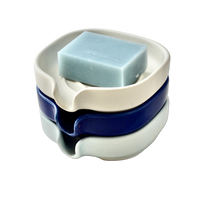 Digital illustration showing cross-section of soap dish draining water away.