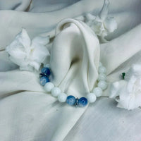 Healing bracelet featuring alternating blue lace agate and white howlite stones with silver accents.