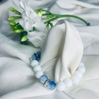 Elegant stretch bracelet with calming blue lace agate and white howlite beads accented by silver.